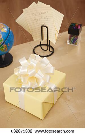 Stock Image - USA, Illinois, Metamora, Gift box on teacher's desk. Fotosearch