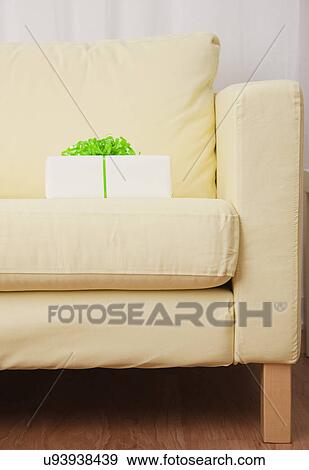 Stock Photo - USA, Illinois, Metamora, Gift box on sofa. Fotosearch