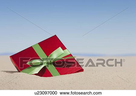 USA, Illinois, Metamora, Gift buried in sand View Large Photo Image Stock Image - USA, Illinois, Metamora, Gift buried in sand. Fotosearch