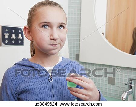Picture - USA, Illinois, Metamora, Girl (10-11) rinsing teeth. Fotosearch