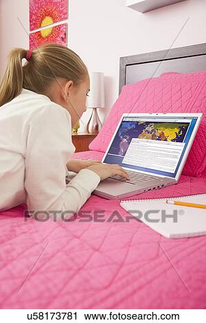 USA, Illinois, Metamora, Girl (10-11) with laptop lying on bed View Large Photo Image Stock Image - USA, Illinois, Metamora, Girl (10-11) with laptop lying on bed. Fotosearch