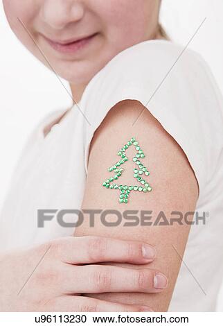 USA, Illinois, Metamora, girl (10-11) with Christmas tree sign on shoulder View Large Photo Image Stock Image - USA, Illinois, Metamora, girl (10-11) with Christmas tree sign on shoulder. Fotosearch