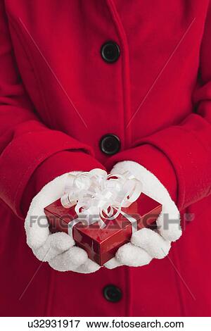 USA, Illinois, Metamora, Girl (10-11) in red coat holding small gift box View Large Photo Image Stock Photo - USA, Illinois, Metamora, Girl (10-11) in red coat holding small gift box. Fotosearch