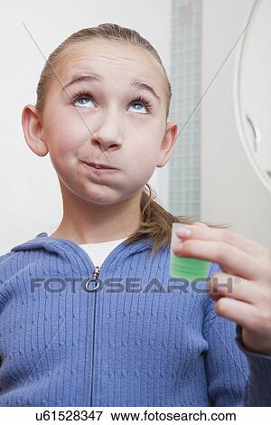 Stock Photo - USA, Illinois, Metamora, Girl (10-11) rinsing teeth. Fotosearch