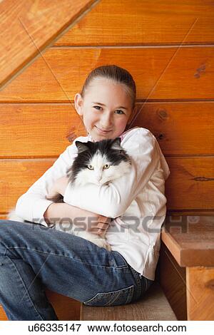 USA, Illinois, Metamora, Girl (10-11) holding cat View Large Photo Image Stock Photo - USA, Illinois, Metamora, Girl (10-11) holding cat. Fotosearch