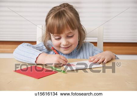 USA, Illinois, Metamora, Girl (4-5) writing Christmas greetings View Large Photo Image Picture - USA, Illinois, Metamora, Girl (4-5) writing Christmas greetings. Fotosearch