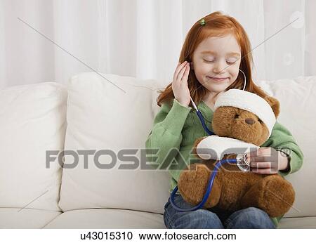 USA, Illinois, Metamora, Girl (4-5) playing with teddy bear and stethoscope View Large Photo Image Stock Image - USA, Illinois, Metamora, Girl (4-5) playing with teddy bear and stethoscope. Fotosearch