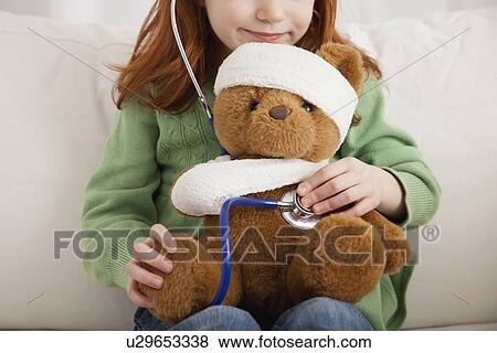 USA, Illinois, Metamora, Girl (4-5) playing with teddy bear and stethoscope View Large Photo Image Stock Photo - USA, Illinois, Metamora, Girl (4-5) playing with teddy bear and stethoscope. Fotosearch
