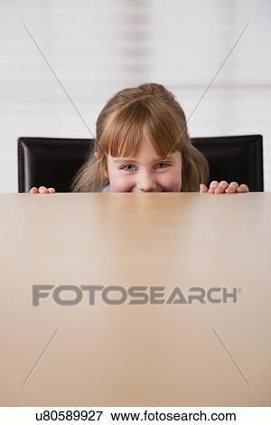 USA, Illinois, Metamora, Girl (4-5) looking at camera over table View Large Photo Image Stock Photo - USA, Illinois, Metamora, Girl (4-5) looking at camera over table. Fotosearch