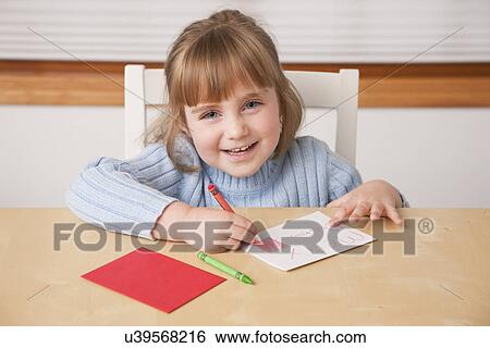 USA, Illinois, Metamora, Girl (4-5) writing Christmas greetings View Large Photo Image Stock Photograph - USA, Illinois, Metamora, Girl (4-5) writing Christmas greetings. Fotosearch