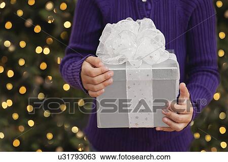 USA, Illinois, Metamora, Girl (6-7) holding gift box View Large Photo Image Stock Image - USA, Illinois, Metamora, Girl (6-7) holding gift box. Fotosearch