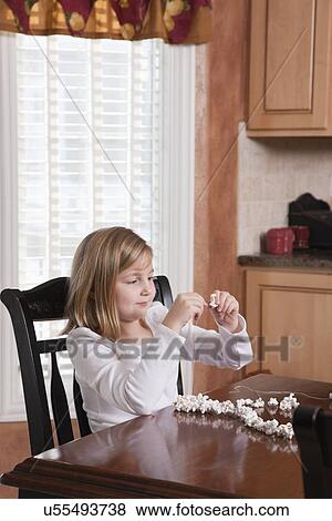 USA, Illinois, Metamora, girl (6-7) making popcorn Christmas ornament View Large Photo Image Stock Photo - USA, Illinois, Metamora, girl (6-7) making popcorn Christmas ornament. Fotosearch