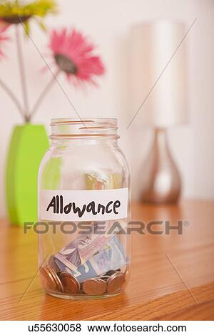 USA, Illinois, Metamora, Glass jar with coins and banknotes on table View Large Photo Image Stock Photo - USA, Illinois, Metamora, Glass jar with coins and banknotes on table. Fotosearch