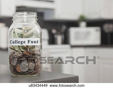 USA, Illinois, Metamora, Glass jar with coins on kitchen counter View Large Photo Image Stock Photo - USA, Illinois, Metamora, Glass jar with coins on kitchen counter. Fotosearch