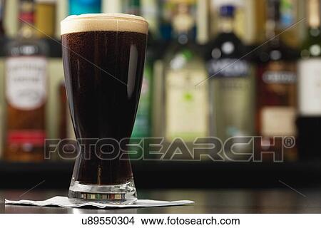 USA, Illinois, Metamora, Glass of dark beer on bar counter View Large Photo Image Picture - USA, Illinois, Metamora, Glass of dark beer on bar counter. Fotosearch