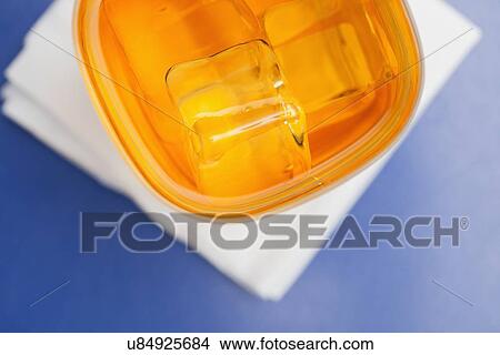 Picture - USA, Illinois, Metamora, Glass of whiskey with ice cubes. Fotosearch