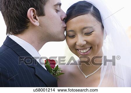 USA, Illinois, Metamora, Groom kissing bride View Large Photo Image Picture - USA, Illinois, Metamora, Groom kissing bride. Fotosearch