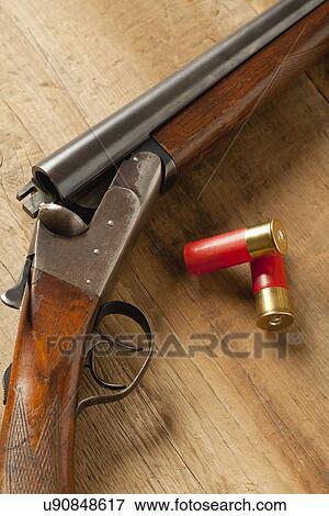 USA, Illinois, Metamora, Gun and bullets on table View Large Photo Image Stock Photo - USA, Illinois, Metamora, Gun and bullets on table. Fotosearch
