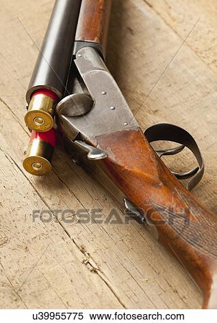 USA, Illinois, Metamora, Gun and bullets on table View Large Photo Image Stock Photography - USA, Illinois, Metamora, Gun and bullets on table. Fotosearch