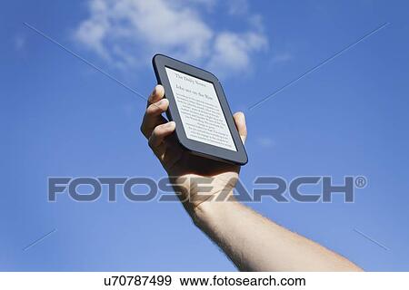 USA, Illinois, Metamora, hand holding up e-book View Large Photo Image Stock Photo - USA, Illinois, Metamora, hand holding up e-book. Fotosearch
