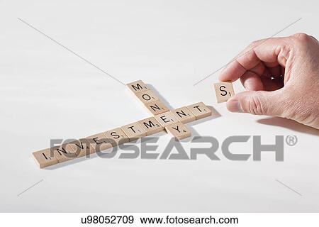 USA, Illinois, Metamora, Hand spelling financial words with game pieces View Large Photo Image Stock Photo - USA, Illinois, Metamora, Hand spelling financial words with game pieces. Fotosearch