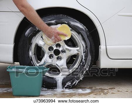 Picture - USA, Illinois, Metamora, Hand washing car. Fotosearch