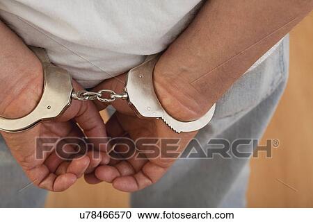 Stock Image - USA, Illinois, Metamora, Handcuffed man. Fotosearch