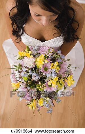 USA, Illinois, Metamora, High angle view of bride holding bouquet View Large Photo Image Picture - USA, Illinois, Metamora, High angle view of bride holding bouquet. Fotosearch