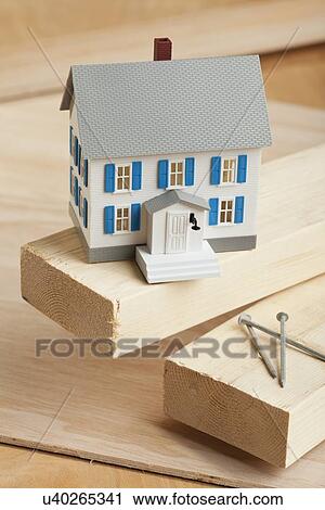Stock Image - USA, Illinois, Metamora, House model on wood. Fotosearch