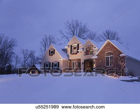 Stock Photo - USA, Illinois, Metamora, house decorated with Christmas lights at dusk. Fotosearch