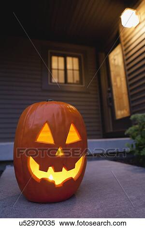 USA, Illinois, Metamora, illuminated jack o' lantern on porch View Large Photo Image Stock Photography - USA, Illinois, Metamora, illuminated jack o' lantern on porch. Fotosearch