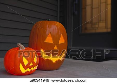 USA, Illinois, Metamora, Jack O'lanterns in front of door View Large Photo Image Stock Photo - USA, Illinois, Metamora, Jack O'lanterns in front of door. Fotosearch