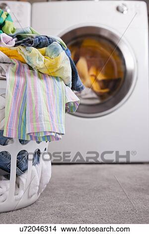 Picture - USA, Illinois, Metamora, laundry basket and washing machine. Fotosearch