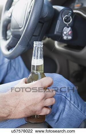 USA, Illinois, Metamora, Man driving with open bottle of beer View Large Photo Image Stock Image - USA, Illinois, Metamora, Man driving with open bottle of beer. Fotosearch