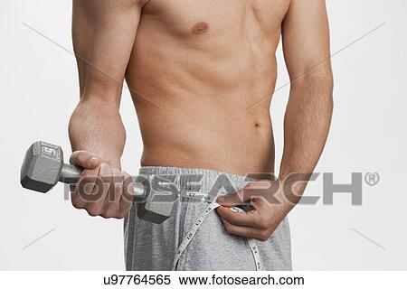 USA, Illinois, Metamora, Man exercising with dumbbell View Large Photo Image Stock Photography - USA, Illinois, Metamora, Man exercising with dumbbell. Fotosearch