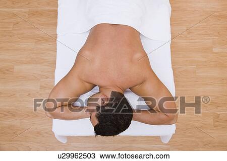 USA, Illinois, Metamora, Man lying on massage table View Large Photo Image Stock Image - USA, Illinois, Metamora, Man lying on massage table. Fotosearch