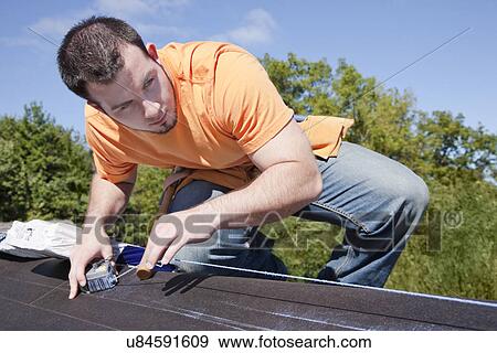 USA, Illinois, Metamora, Man measuring with chalk dust on roof View Large Photo Image Stock Photo - USA, Illinois, Metamora, Man measuring with chalk dust on roof. Fotosearch