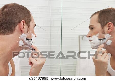 USA, Illinois, Metamora, Man shaving in front of mirror View Large Photo Image Stock Photography - USA, Illinois, Metamora, Man shaving in front of mirror. Fotosearch