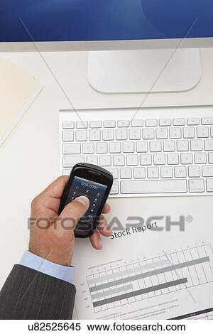USA, Illinois, Metamora, Man texting on his mobile in office View Large Photo Image Stock Photography - USA, Illinois, Metamora, Man texting on his mobile in office. Fotosearch