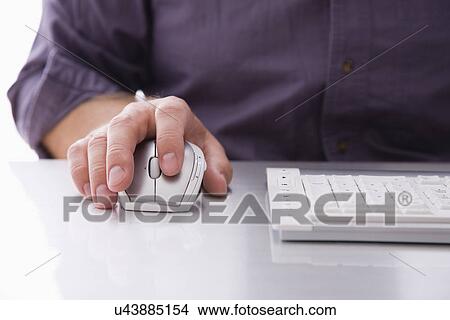 Picture - USA, Illinois, Metamora, Man using computer, close-up of hand on mouse. Fotosearch