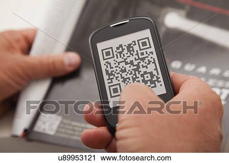 Stock Image - USA, Illinois, Metamora, Man using smart phone device. Fotosearch