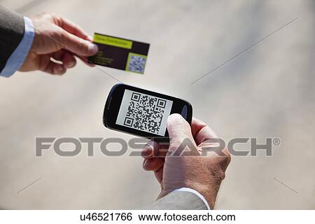 Stock Photograph - USA, Illinois, Metamora, Man using smart phone device. Fotosearch