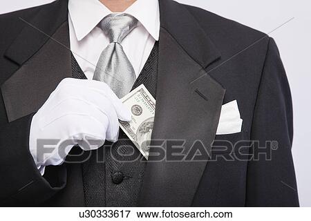 USA, Illinois, Metamora, Man wearing tuxedo holding hundred dollar banknote, mid section View Large Photo Image Stock Photo - USA, Illinois, Metamora, Man wearing tuxedo holding hundred dollar banknote, mid section. Fotosearch
