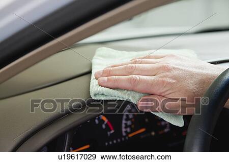 Stock Photo - USA, Illinois, Metamora, Man's hand cleaning dashboard. Fotosearch