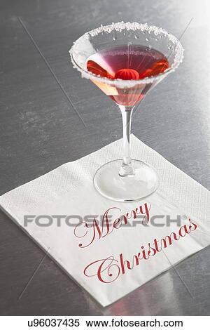 Stock Photography - USA, Illinois, Metamora, Martini glass with "Merry Christmas" napkin. Fotosearch