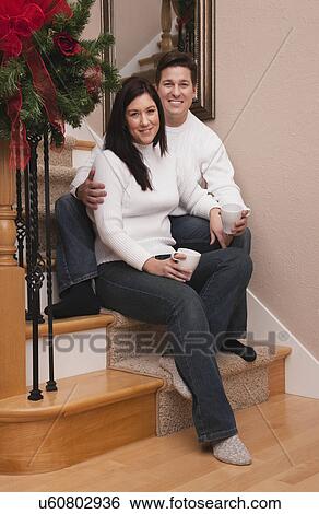 USA, Illinois, Metamora, mid adult couple sitting on steps and holding mugs View Large Photo Image Stock Photograph - USA, Illinois, Metamora, mid adult couple sitting on steps and holding mugs. Fotosearch