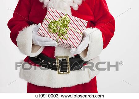 USA, Illinois, Metamora, Midsection of Santa Claus holding gift View Large Photo Image Stock Image - USA, Illinois, Metamora, Midsection of Santa Claus holding gift. Fotosearch