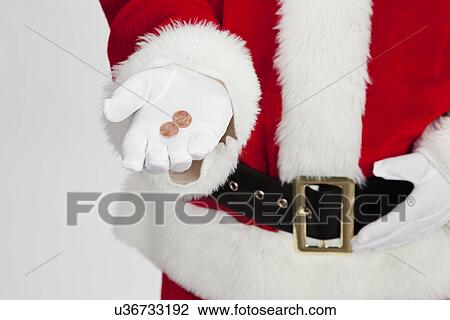 Stock Image - USA, Illinois, Metamora, Midsection of Santa Claus holding coins. Fotosearch