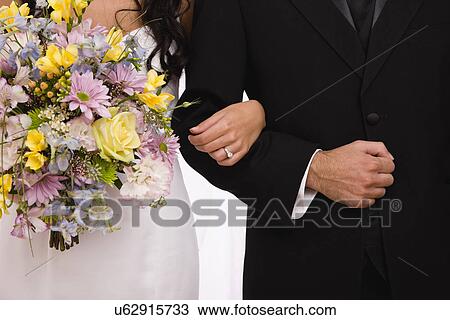 Stock Image - USA, Illinois, Metamora, midsection of bride and groom. Fotosearch