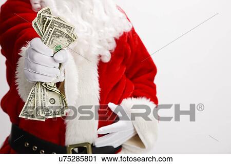 Stock Image - USA, Illinois, Metamora, Midsection of Santa Claus holding cash. Fotosearch